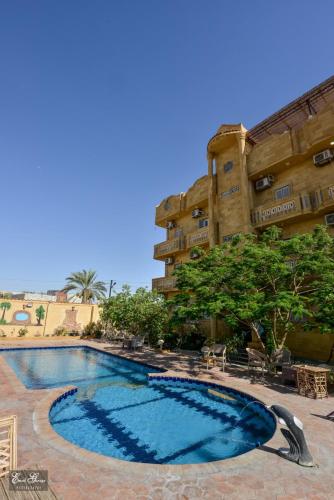 a large swimming pool in front of a building at Qasr El salam in Siwa