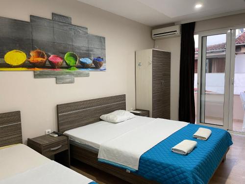 a bedroom with a bed with two towels on it at Apartments Lati in Ulcinj