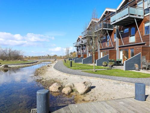 a house with a river next to a building at 4 person holiday home in Bogense in Bogense