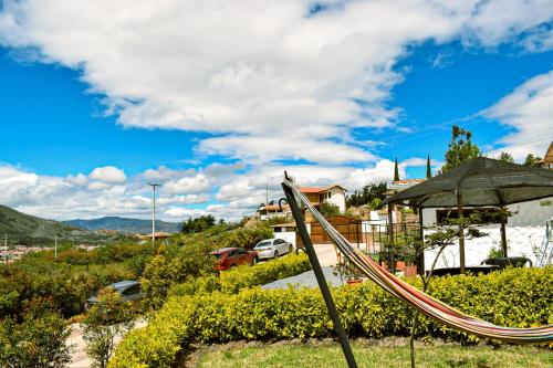 a playground with a slide and an umbrella at Posada Tierra Viva in Villa de Leyva