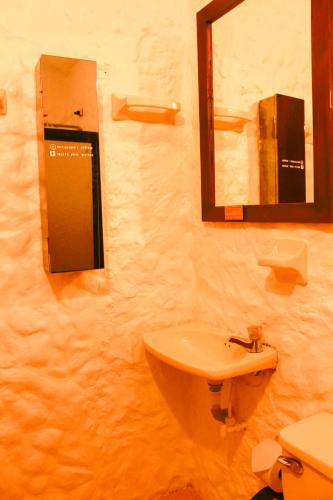a bathroom with a sink and a mirror at Casa Encuentro Ecolodge, Outdoor Gym and Yoga in Guatapé