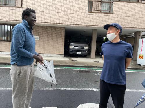 a man with a mask on his face and a man with a newspaper at Hostel 1010 TOKYO in Tokyo