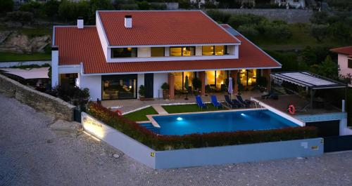 an aerial view of a house with a swimming pool at Casa D'Os Reais in São Cristóvão do Douro