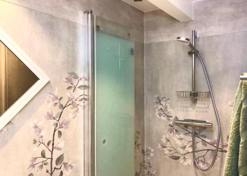 a shower with a glass door in a bathroom at Tryde 1303 B&B på Österlen in Tomelilla