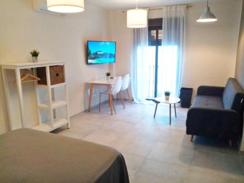 a living room with a couch and a table at Beach Apartments Old Town in Estepona