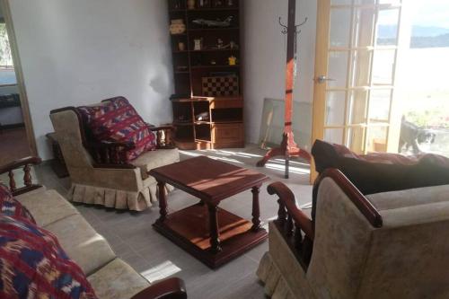 a living room filled with furniture and a table at El Cascajal: Amazing lake view. Vista al lago in Guatavita