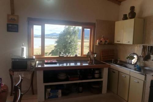a kitchen with a sink and a window at El Cascajal: Amazing lake view. Vista al lago in Guatavita