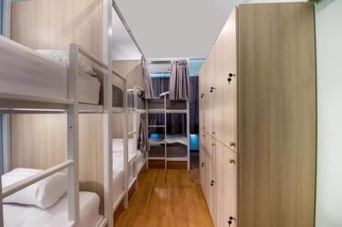 a dorm room with bunk beds and a hallway at Nature Village Hostel in Lak Si