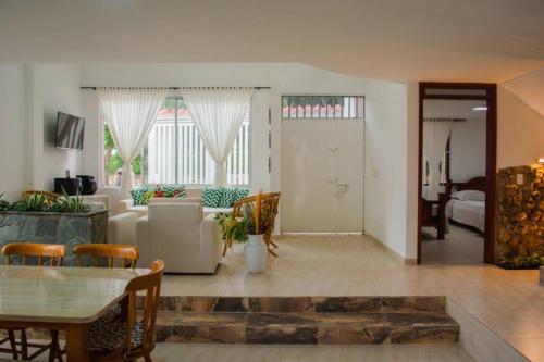 a living room with a couch and a table at Estratégica Ubicación-Energía Renovable-Pet Friendly in Anapoima