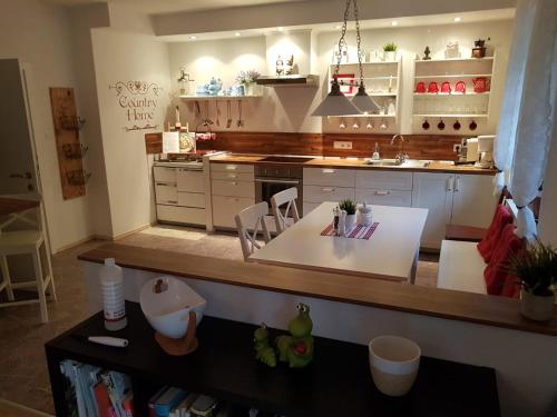 a kitchen with a table and a counter top at Feriendomizil Wetzelberger in Mönichwald