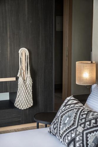 a bedroom with a bed and a table with a bag at panorama new generation in Sfakia