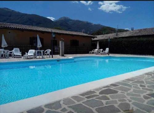 a large blue swimming pool in front of a house at Chalet San Massimo in San Massimo