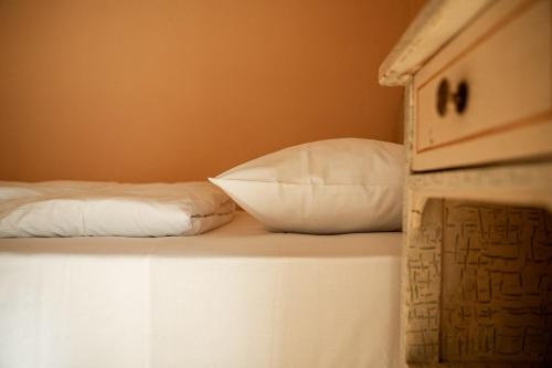 a bunk bed with two pillows on top of it at Belvedere Dolomites Flower Hotel in Moena