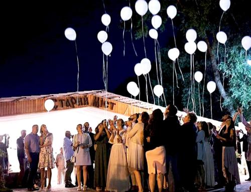 a group of people standing in front of a building with white balloons at Котедж-парк Славна in Okhtyrka