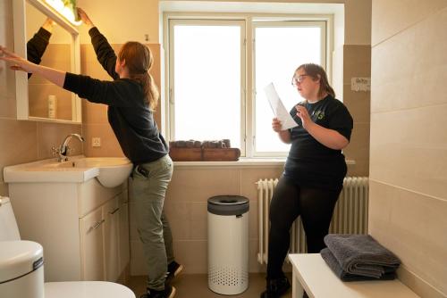two women standing in a bathroom looking in the mirror at Villa Sofie Bed & Breakfast in Haslev