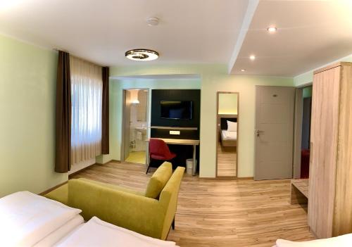 a hotel room with a bed and a living room at Hotel zur Flüh in Bad Säckingen