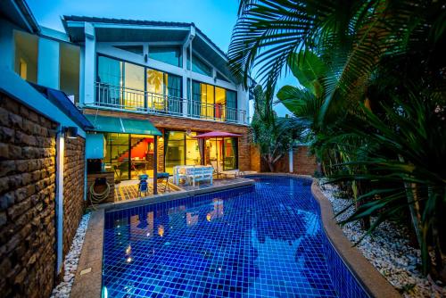 a large swimming pool in front of a large building at 4poolvillas in Pattaya North