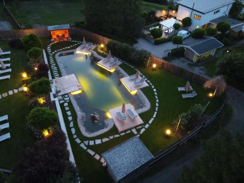 an overhead view of a backyard with a swimming pool at night at Hotel Seppl in Innsbruck