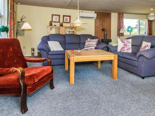 a living room with two couches and a coffee table at 6 person holiday home in R m in Kongsmark