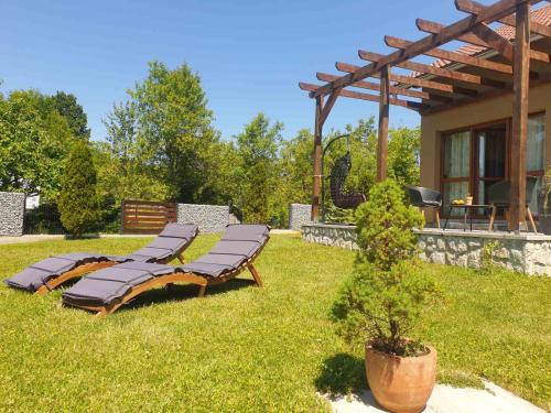 a group of lounges on the grass near a house at Donna in Grabovac