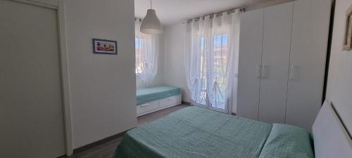 a small bedroom with a bed and a window at Appartamenti Lino in Caorle