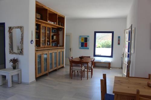a living room with a table and a dining room at Beach Villa Akrotiri in Engares