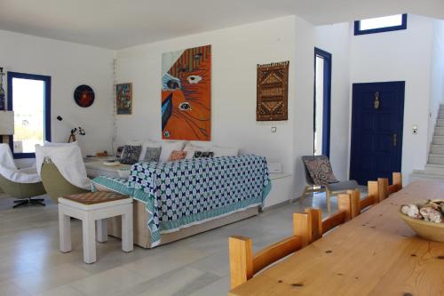 a living room with a couch and a table at Beach Villa Akrotiri in Engares