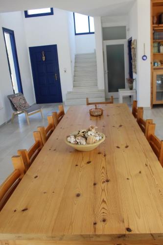 a wooden table with a bowl of mushrooms on it at Beach Villa Akrotiri in Engares