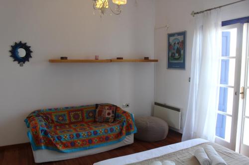 a room with a bed and a chair and a window at Beach Villa Akrotiri in Engares
