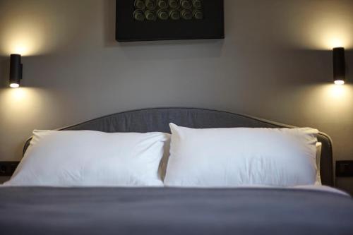 a bed with two white pillows in a room at Soldeu Gall de Bosc Luxury Apartment apt Bon aire HUT1-7893 in Soldeu