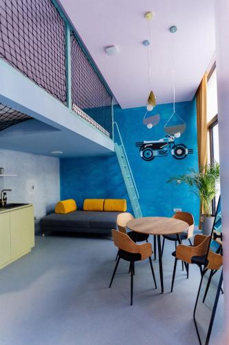 a room with a staircase and a table and chairs at Tomosmatik Apartments Koper by Locap Group in Koper