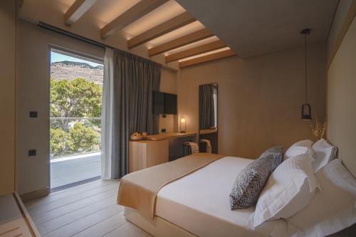 a bedroom with a large bed and a large window at panorama new generation in Sfakia