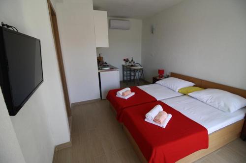 a bedroom with a bed with two towels on it at Apartment Gita in Sumartin