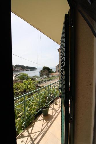 a balcony with a view of a body of water at Apartment Gita in Sumartin