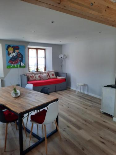 a living room with a table and a couch at Gîte du Val'Soleil in Villé