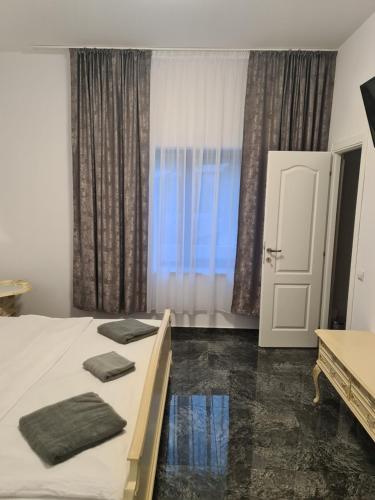 a bedroom with a bed with two pillows on it at Casa Piri in Anina
