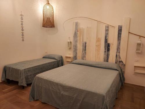 سرير أو أسرّة في غرفة في Casa vacanze vista mare Salento Tricase Porto villa Antonio e villa Rosanna