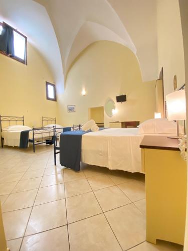 a hospital room with a bed and a table at Al Pescatore Hotel & Restaurant in Gallipoli