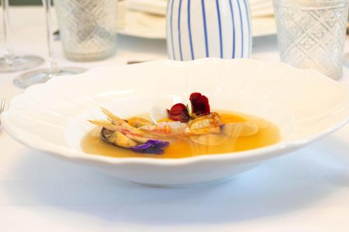 a white bowl of food on a table at Heritage Hotel Porin Makarska in Makarska