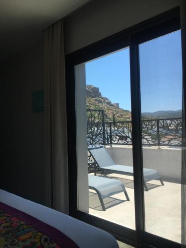 a room with a window with a view of a balcony at Villa Oliva Butik Hotel in Bodrum City