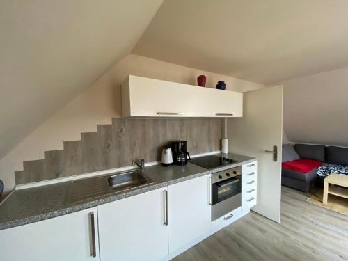 a kitchen with a sink and a counter top at Gästehaus VillaVerde in Kelberg