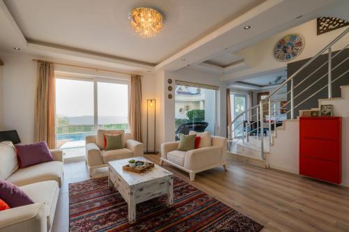 a living room with a couch and chairs and a table at Milez Sultan luxury villa by Solo Villa in Oludeniz
