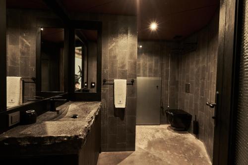 a bathroom with two sinks and a toilet and a mirror at Carus Cappadocia in Goreme