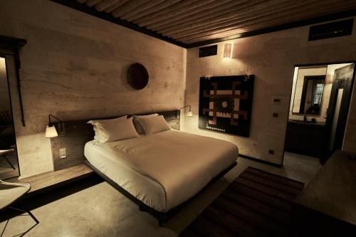 a bedroom with a white bed in a room at Carus Cappadocia in Goreme