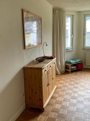 a room with a wooden cabinet with a basket on top at Gästehaus VillaVerde in Kelberg