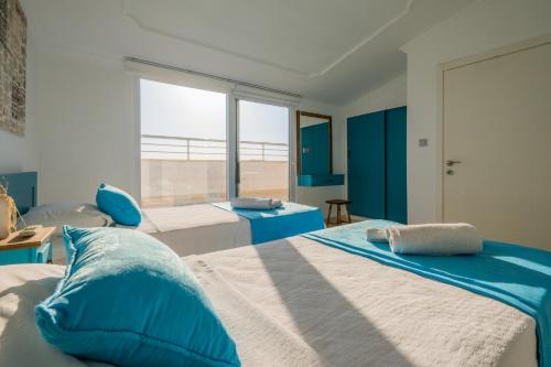 a bedroom with two beds with blue and white at Milez Sultan luxury villa by Solo Villa in Oludeniz