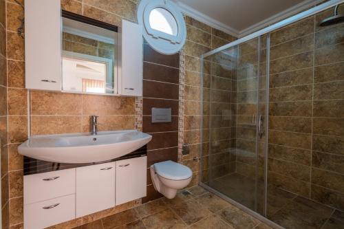 a bathroom with a toilet and a sink and a shower at Milez Sultan luxury villa by Solo Villa in Oludeniz