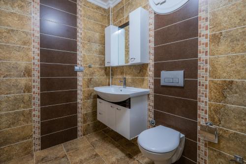 a bathroom with a toilet and a sink at Milez Sultan luxury villa by Solo Villa in Oludeniz