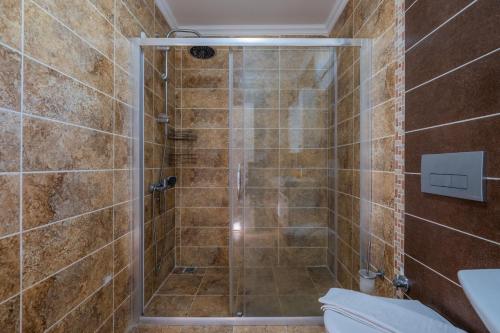 a bathroom with a shower with a toilet at Milez Sultan luxury villa by Solo Villa in Oludeniz