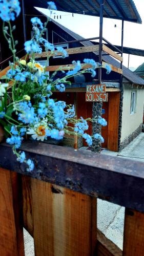 a table with blue flowers on top of a building at Kesane in Jut'a
